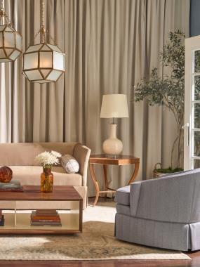Room Scene: HC713-51-5 Addie M2M® Chair / Sofa with Kick Pleat Skirt shown in HC363-62 body fabric with bolsters shown in HC499-32 fabric; PE6707-22 Ember Exposed Wood Lounge Chair shown in HC499-34 fabric with HC426-72 welt and Chestnut finish; PE6707-27 Ember Skirted Swivel shown in HC499-34 fabric with HC426-72 welt; HC7879-70 Hadley Cocktail Table shown in Cream Linen finish on inside and Chestnut finish on outside and HCP292-STK Darcy End Table.