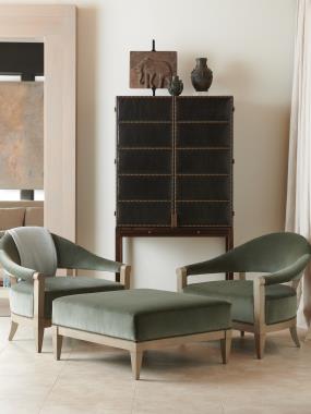 Room Scene: HC7267-70 Russell Cabinet shown in optional Dark Walnut finish and in COL leather  with NS-05 Small Natural Nail head trim and HC7218-22 Crescent Chair and HC7218-29 Ottoman shown in optional Weathered Stone paint and in COM fabric.